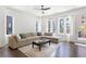 Cozy living room features hardwood floors, a large sectional sofa, and plenty of natural light from the windows at 1244 Chelsea Nw Cir, Atlanta, GA 30318