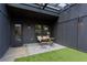Cozy outdoor patio area with artificial turf, covered pergola, table, and seating for relaxing at 1244 Chelsea Nw Cir, Atlanta, GA 30318