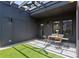 Stylish outdoor patio with artificial turf, pergola, and charming seating arrangement at 1244 Chelsea Nw Cir, Atlanta, GA 30318
