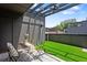 Charming rooftop terrace with artificial grass, stylish furniture, and a pergola for shade at 1244 Chelsea Nw Cir, Atlanta, GA 30318