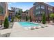 Community swimming pool with lounge chairs, landscaping, and views of modern townhomes at 1244 Chelsea Nw Cir, Atlanta, GA 30318