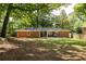 A brick home's back exterior with a cozy screened porch and grill on the patio, perfect for outdoor gatherings at 1597 Fama Ne Dr, Atlanta, GA 30329