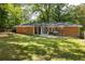 Back exterior view showcasing a brick home with a screened porch and a grill on the patio, ideal for entertaining at 1597 Fama Ne Dr, Atlanta, GA 30329