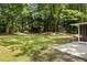 Spacious backyard featuring a large grassy area and mature trees, perfect for outdoor activities and relaxation at 1597 Fama Ne Dr, Atlanta, GA 30329