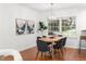 Dining area with an oval table, modern decor, bright light fixture and hardwood floors at 1597 Fama Ne Dr, Atlanta, GA 30329