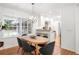 Bright dining area with wood table, modern light fixture, and view of the backyard at 1597 Fama Ne Dr, Atlanta, GA 30329