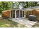 Rear exterior view of the home showing the porch, grill, and back yard at 1597 Fama Ne Dr, Atlanta, GA 30329
