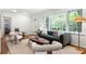 Bright living room with large windows, modern decor, and beautiful hardwood floors at 1597 Fama Ne Dr, Atlanta, GA 30329
