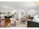 Open concept living and dining area with hardwood floors and lots of light from large windows at 1597 Fama Ne Dr, Atlanta, GA 30329