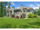 Backyard of the house with beautiful lawn, screened porch, and deck at 208 Wilshire Ter, White, GA 30184