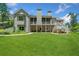 Expansive backyard featuring a well-manicured lawn, screened porch, and deck at 208 Wilshire Ter, White, GA 30184