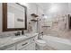 Well-lit bathroom with a shower-tub combo, vanity with granite counters, and decorative wood shelves at 208 Wilshire Ter, White, GA 30184