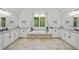 Luxurious bathroom featuring a soaking tub, double vanity, and beautiful tile flooring for a spa-like experience at 208 Wilshire Ter, White, GA 30184