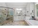 Elegant bathroom featuring a glass shower, soaking tub, and granite counters for a spa-like retreat at 208 Wilshire Ter, White, GA 30184