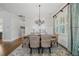 Traditional dining room with wainscoting, elegant chandelier, and textured rug at 208 Wilshire Ter, White, GA 30184