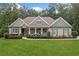 Charming single-story home featuring a manicured lawn and a welcoming front porch with rocking chairs at 208 Wilshire Ter, White, GA 30184