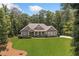 Beautifully landscaped home with a sprawling green lawn and mature trees at 208 Wilshire Ter, White, GA 30184