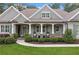 Inviting front porch with rocking chairs and elegant landscaping at 208 Wilshire Ter, White, GA 30184