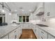 Bright kitchen with white cabinets, granite countertops, and stainless-steel appliances at 208 Wilshire Ter, White, GA 30184