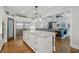Spacious kitchen with island seating, custom cabinets, and stainless refrigerator at 208 Wilshire Ter, White, GA 30184