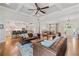 Open living room with hardwood floors, designer furniture, and modern lighting at 208 Wilshire Ter, White, GA 30184
