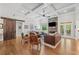 Bright living room featuring a stone fireplace, hardwood floors, and access to outdoor space at 208 Wilshire Ter, White, GA 30184