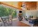 Inviting screened porch with ceiling fans, fireplace, TV, and comfortable seating for outdoor relaxation at 208 Wilshire Ter, White, GA 30184