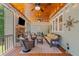 Relaxing screened porch with wood ceiling, ceiling fans, and cozy wicker furniture, perfect for entertaining at 208 Wilshire Ter, White, GA 30184