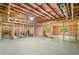 Spacious unfinished basement with exposed framing, insulation, and natural light from a window at 208 Wilshire Ter, White, GA 30184