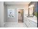 Elegant bathroom with double vanity, modern tile and a glimpse of a walk-in closet at 392 Pratt Dr # 2014, Atlanta, GA 30315