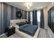 Comfortable bedroom features accent wall and a large window with window treatments at 392 Pratt Dr # 2014, Atlanta, GA 30315