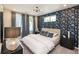 Serene bedroom featuring a patterned accent wall, large windows, and modern furnishings at 392 Pratt Dr # 2014, Atlanta, GA 30315