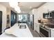 Bright kitchen with white cabinets, stainless steel appliances, and a view into the dining area at 392 Pratt Dr # 2014, Atlanta, GA 30315