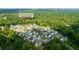 An aerial view showcases a neighborhood with neatly arranged modern homes surrounded by lush green trees in Atlanta, Georgia at 4503 Atley Woods Se Dr, Atlanta, GA 30339