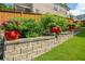 Retaining wall with colorful potted plants overlooking a manicured lawn at 4503 Atley Woods Se Dr, Atlanta, GA 30339
