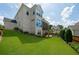 Expansive backyard with manicured lawn, screened porch, patio, and lush greenery creating a perfect outdoor oasis at 4503 Atley Woods Se Dr, Atlanta, GA 30339