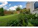 Lush backyard with a healthy lawn and a garden bed with several plants and flowers at 4503 Atley Woods Se Dr, Atlanta, GA 30339