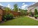 Private backyard featuring a well-maintained lawn bordered by a wooden fence and lush greenery at 4503 Atley Woods Se Dr, Atlanta, GA 30339