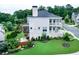 Spacious backyard featuring lush green lawn, screened porch, outdoor seating area and landscaped garden at 4503 Atley Woods Se Dr, Atlanta, GA 30339