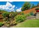 Landscaped backyard featuring a garden bed, retaining wall, and privacy fence at 4503 Atley Woods Se Dr, Atlanta, GA 30339