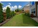 Well-manicured backyard featuring lush green lawn, mature trees and landscaping offering privacy and beauty at 4503 Atley Woods Se Dr, Atlanta, GA 30339