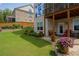 Backyard with patio, featuring well-kept lawn, landscaping, and a view of the home's exterior at 4503 Atley Woods Se Dr, Atlanta, GA 30339