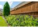 Colorful garden bed with a bird feeder and wooden privacy fence at 4503 Atley Woods Se Dr, Atlanta, GA 30339