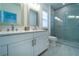Modern bathroom featuring double vanity with stone countertop and a glass-enclosed walk-in shower at 4503 Atley Woods Se Dr, Atlanta, GA 30339