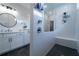 Modern bathroom featuring a glass-enclosed shower, sleek vanity with round mirror, and dark tile floors at 4503 Atley Woods Se Dr, Atlanta, GA 30339