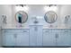 A bathroom boasts dual vanities, modern mirrors, and white tiling at 4503 Atley Woods Se Dr, Atlanta, GA 30339