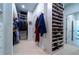 Well-organized walk-in closet with custom shelving, hanging rods, and shoe racks for ample storage at 4503 Atley Woods Se Dr, Atlanta, GA 30339