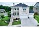 Beautiful two-story brick home featuring dual porches, manicured lawn, attached garage, and professional landscaping at 4503 Atley Woods Se Dr, Atlanta, GA 30339