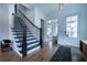 Elegant foyer featuring hardwood floors, staircase, and a white door, creating a bright entryway at 4503 Atley Woods Se Dr, Atlanta, GA 30339
