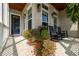 Inviting front porch with seating, hanging plants, brick flooring and view of the front door at 4503 Atley Woods Se Dr, Atlanta, GA 30339